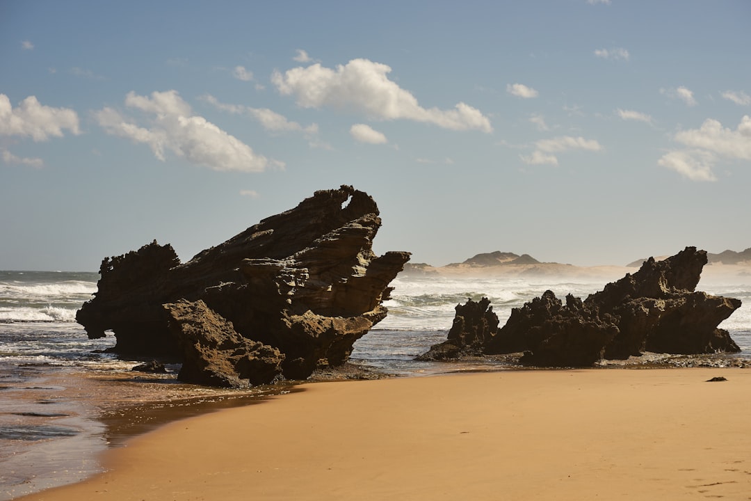 brown rock formation on beach during daytime