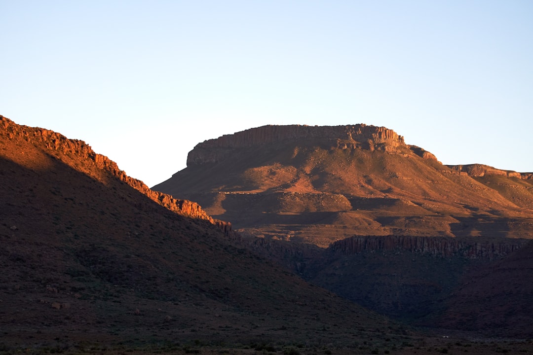 brown and green mountains under white sky during daytime