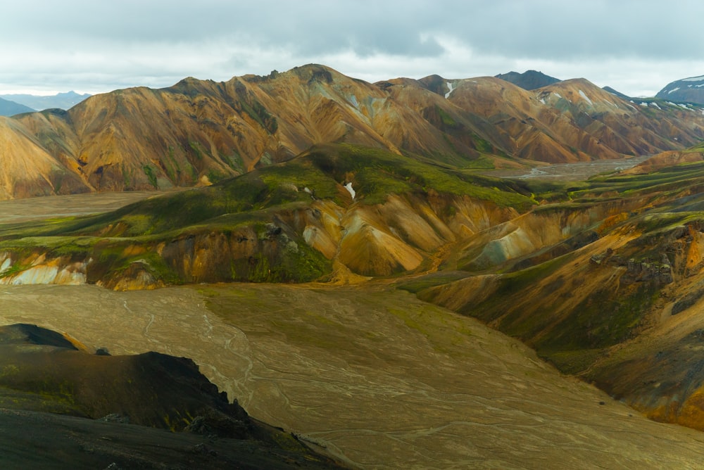 green and brown mountains under white sky during daytime