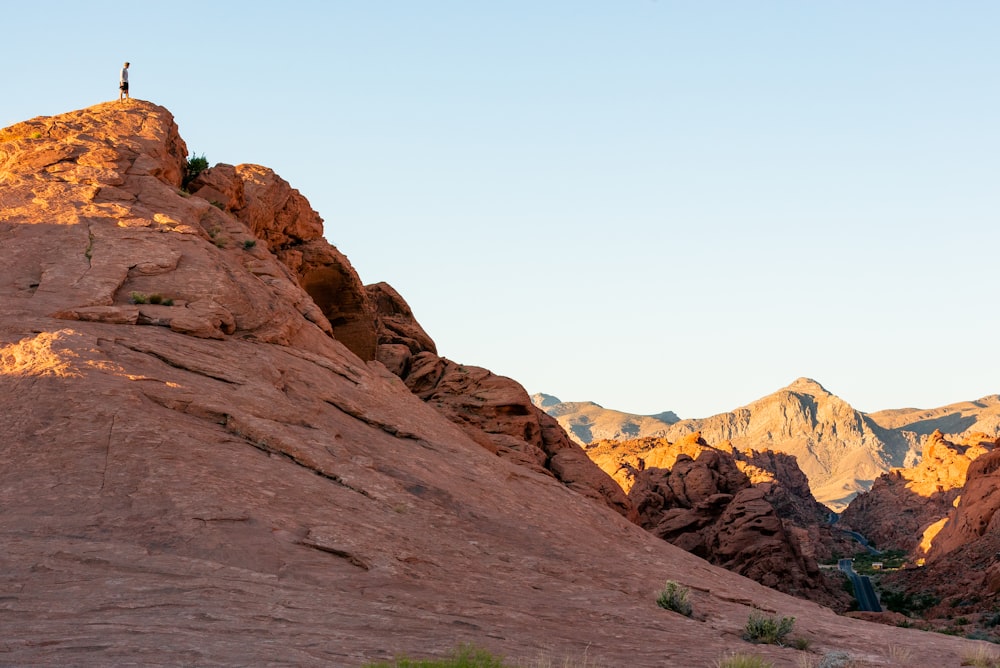 a person standing on top of a large rock