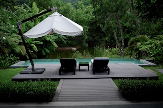 white patio umbrella near swimming pool