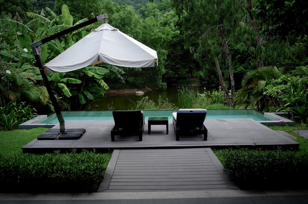 white patio umbrella near swimming pool