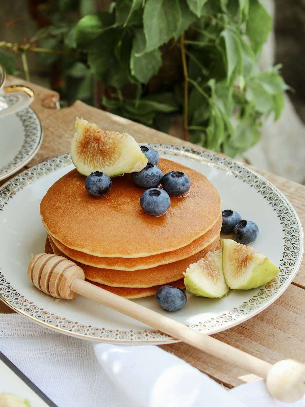 brown cake with blue berries on white ceramic plate