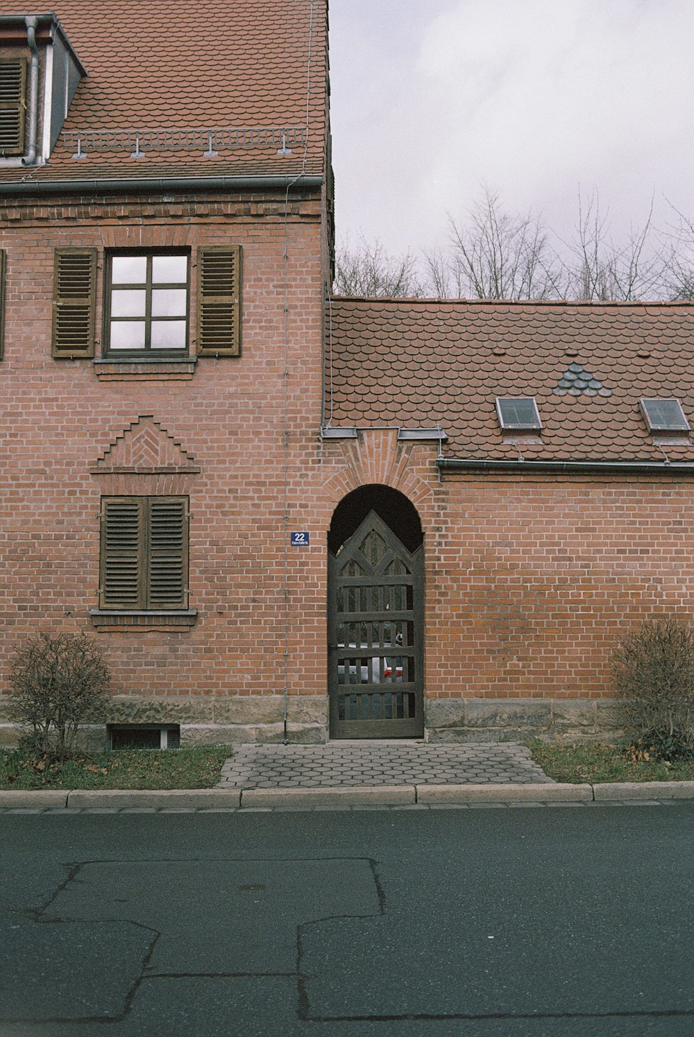 brown brick building with trees in front