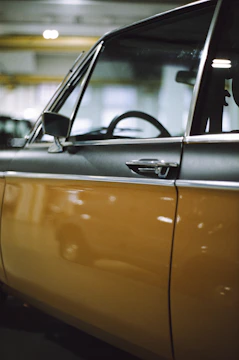 Close-up of a sleek car door being expertly repaired in a modern workshop