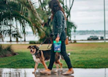 A smiling dog owner gratefully handing over a bag of collected waste during a walk in Leawood park.