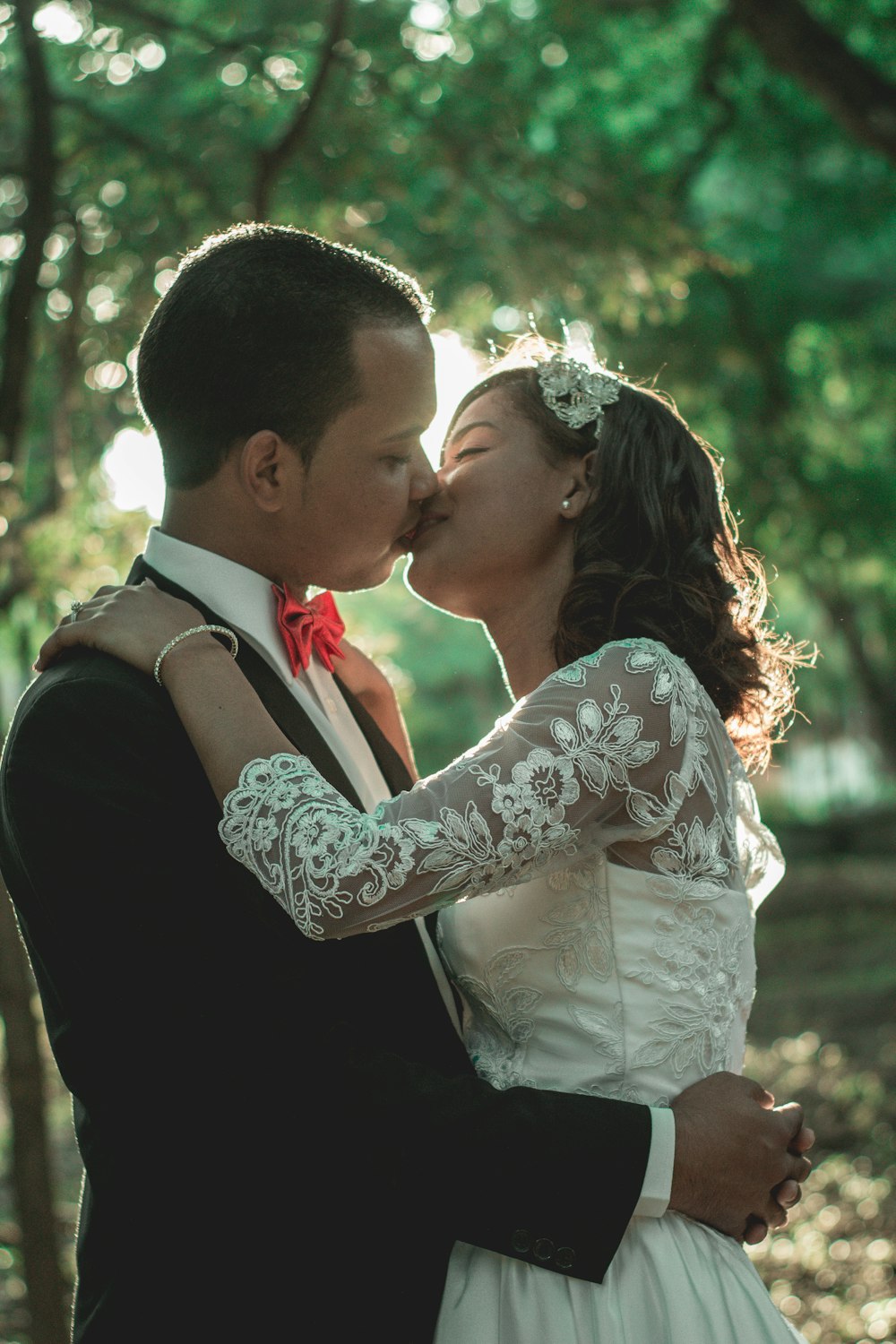 man and woman kissing during daytime