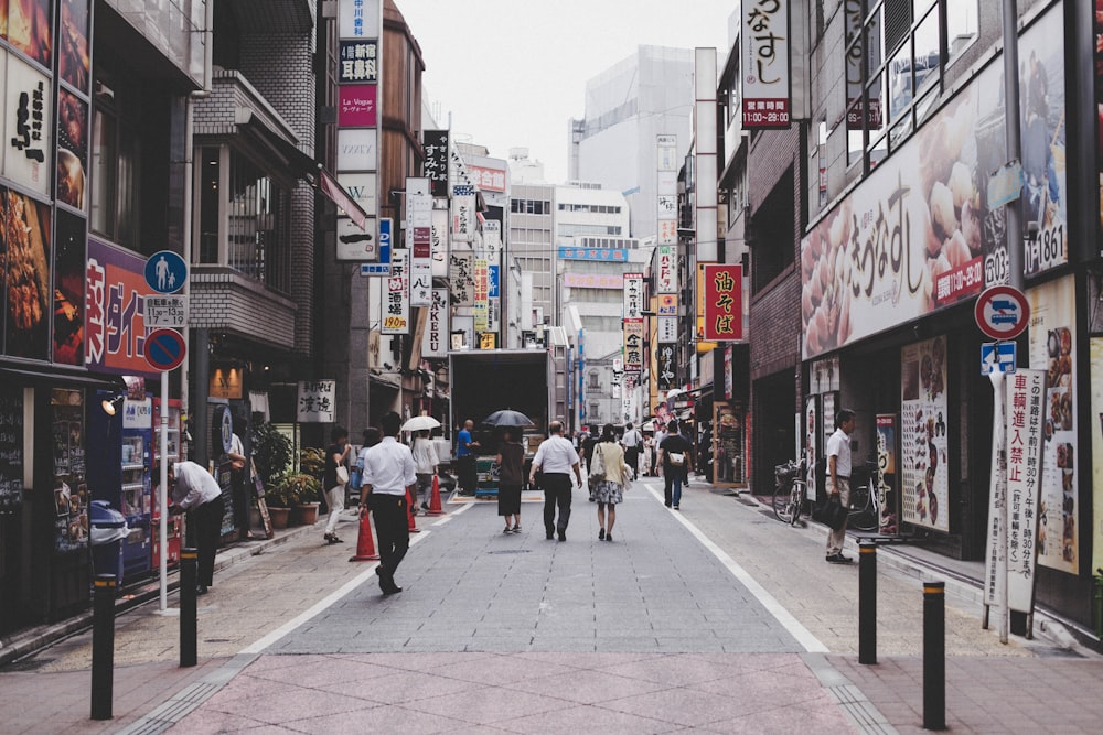 people walking on sidewalk during daytime