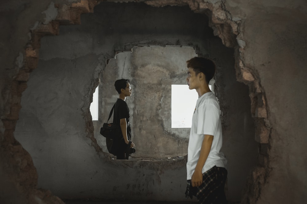 man in white shirt standing in tunnel