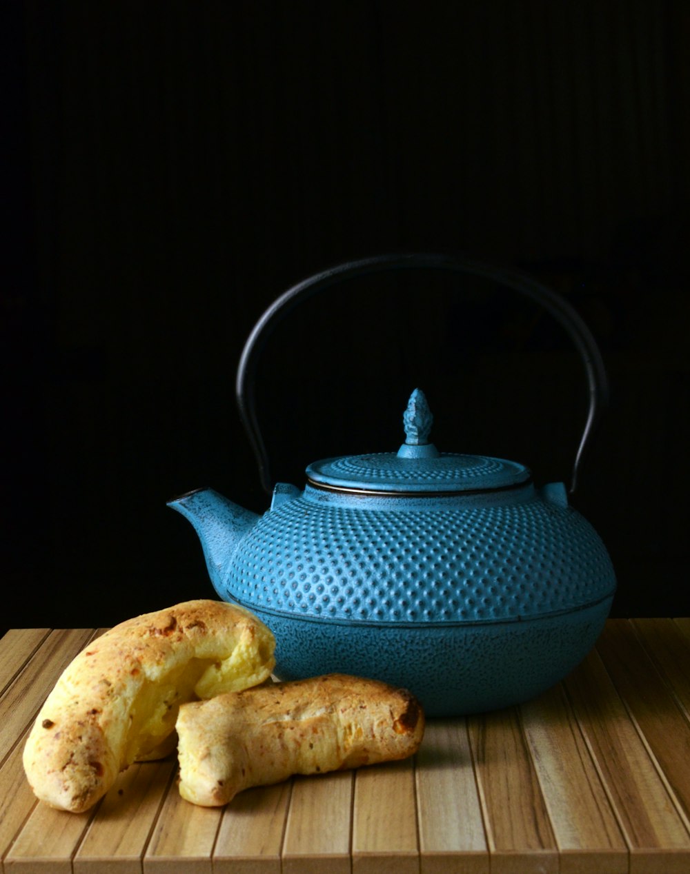 blue ceramic teapot on brown wooden table