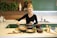 A happy customer using Revora kitchen tools in her kitchen.