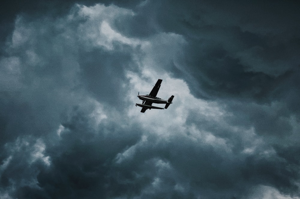 white airplane flying in the sky during daytime