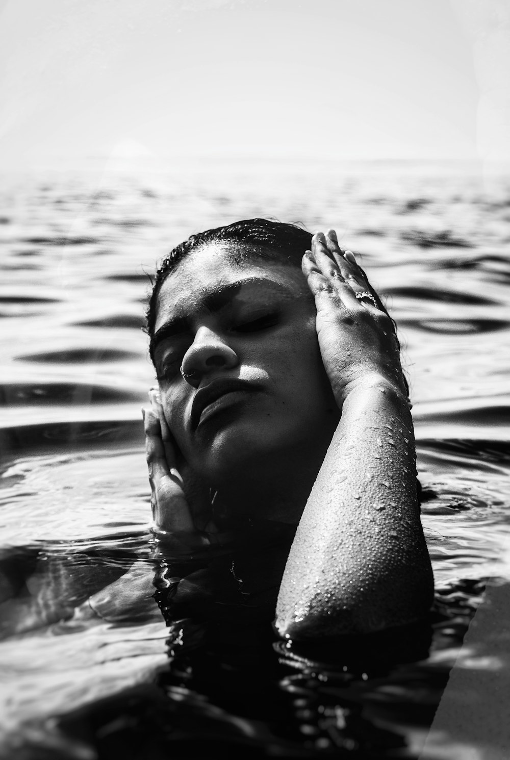 grayscale photo of woman in water