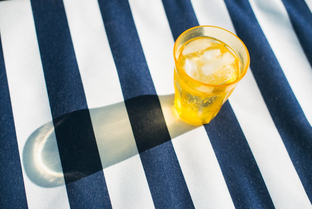 clear drinking glass with yellow liquid