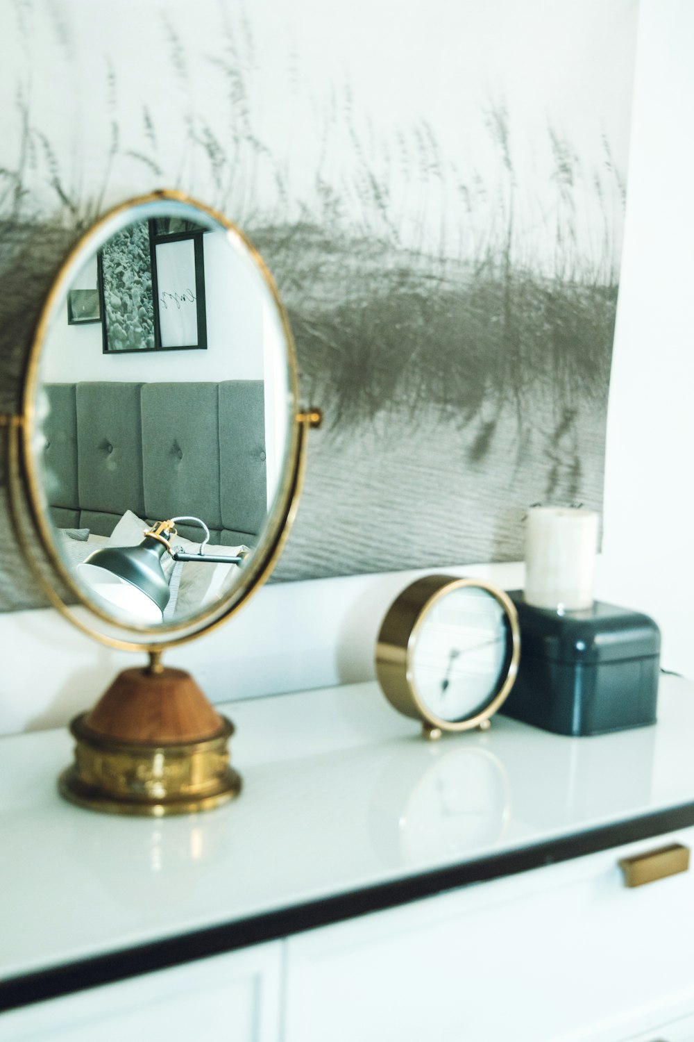 gold and white round framed mirror