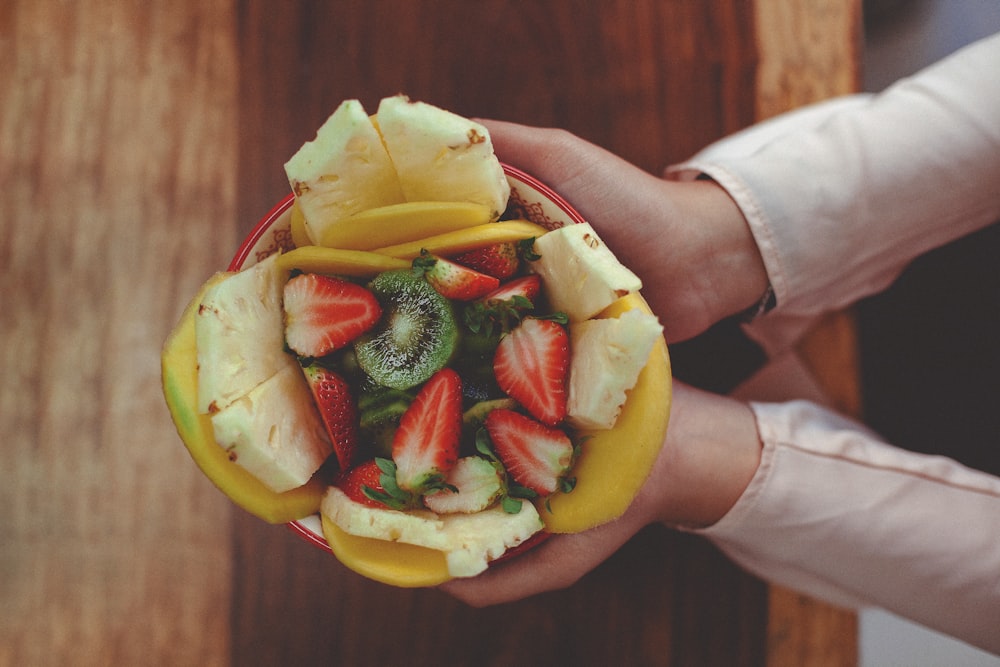 person holding sliced fruit with sliced fruit