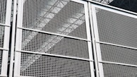 A close-up of a heavy-duty steel grid used in industrial applications.