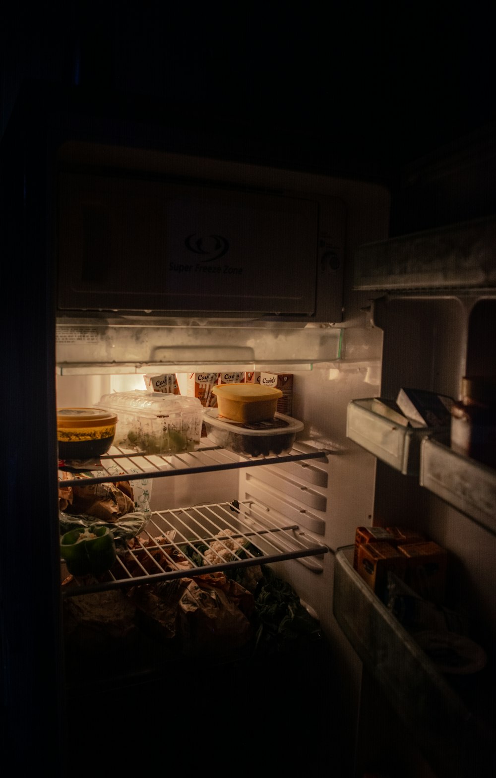 white refrigerator with food inside