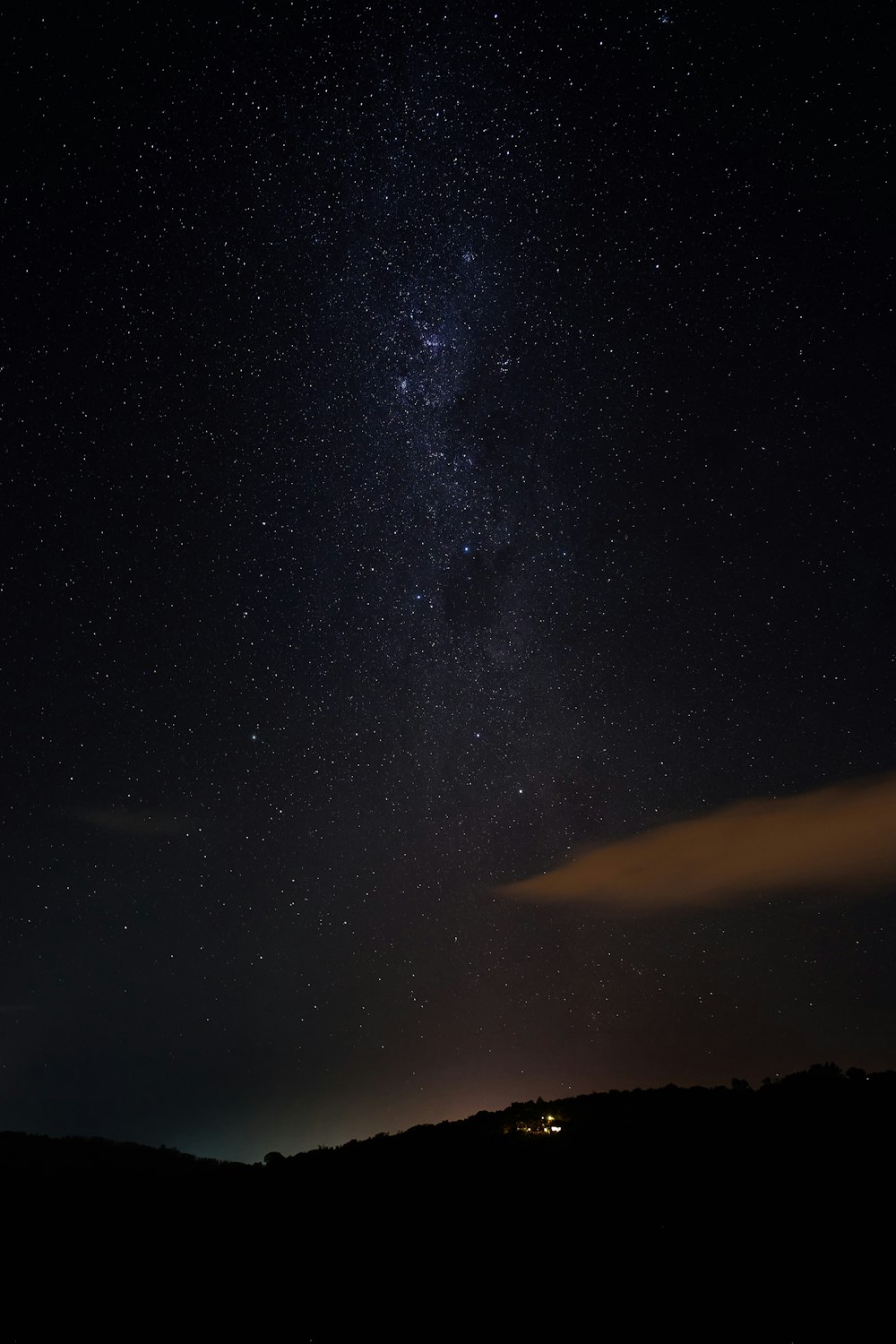 silhouette of mountain under starry night