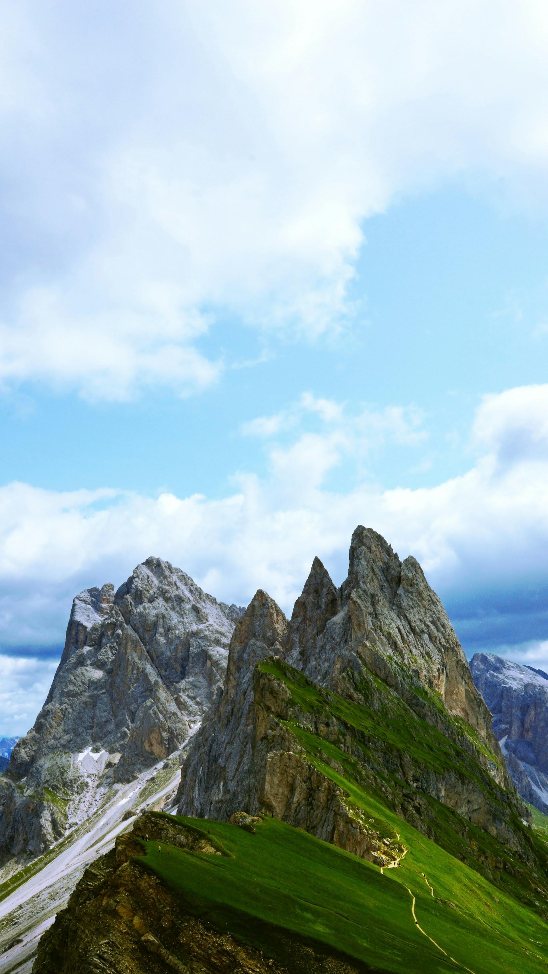 rocky mountain under white clouds during daytime