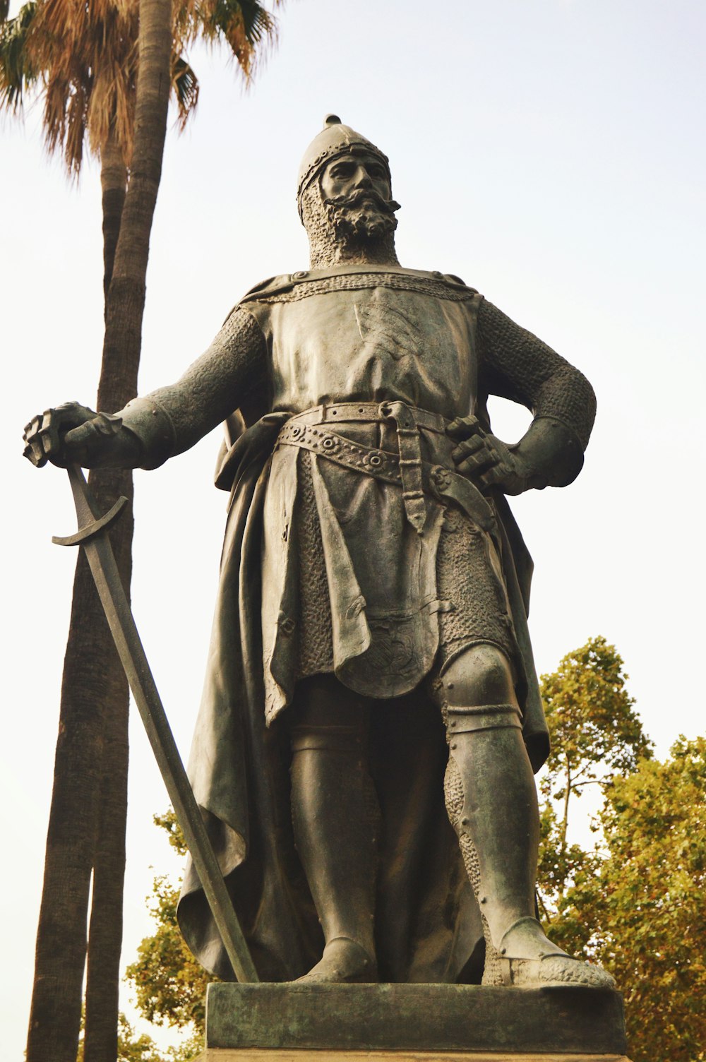 man holding a sword statue