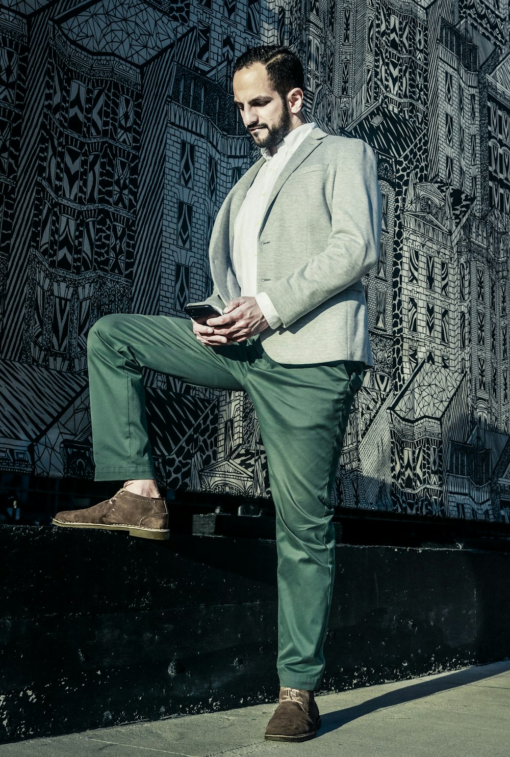 man in gray suit jacket and green pants