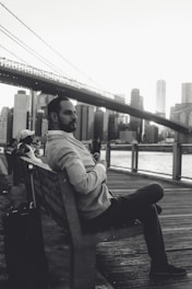 A traveler admiring a famous city landmark with a suitcase nearby.