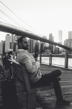 A traveler admiring a famous city landmark with a suitcase nearby.