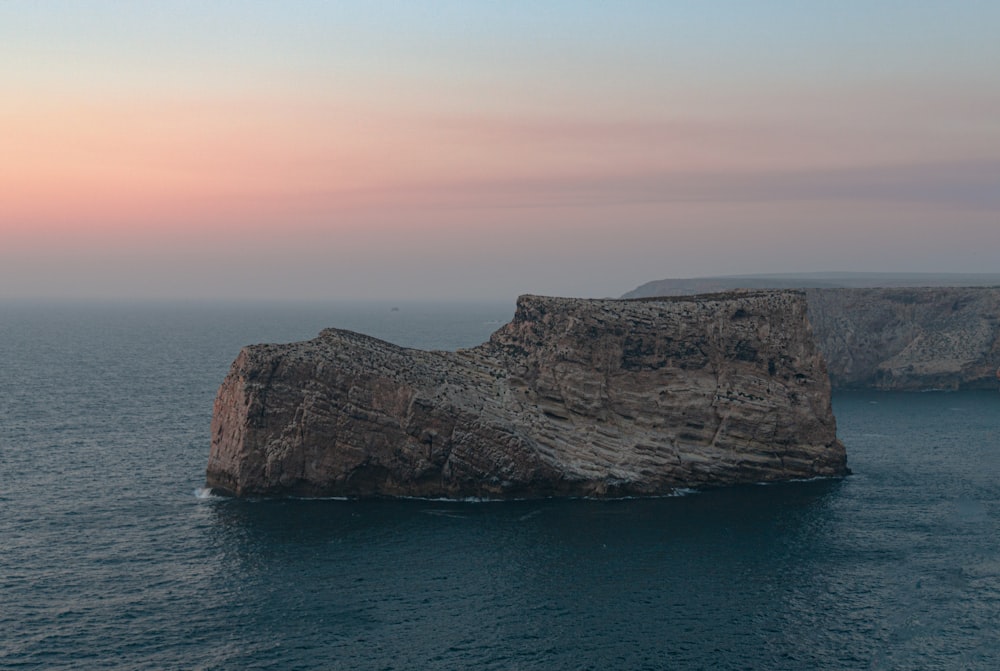 brown rock formation on sea during daytime