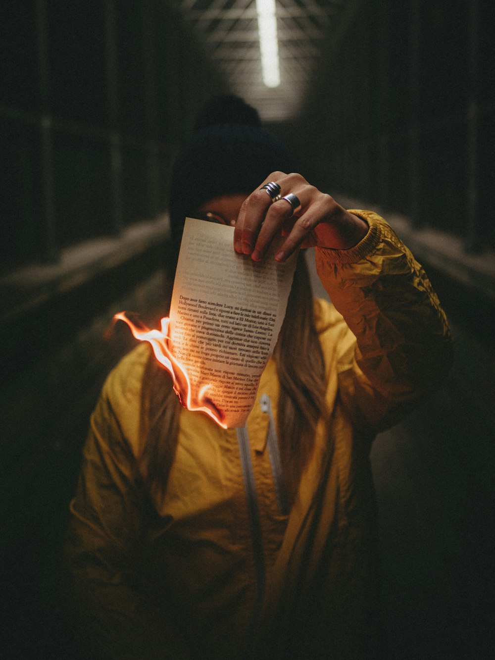 man in brown zip up jacket reading book