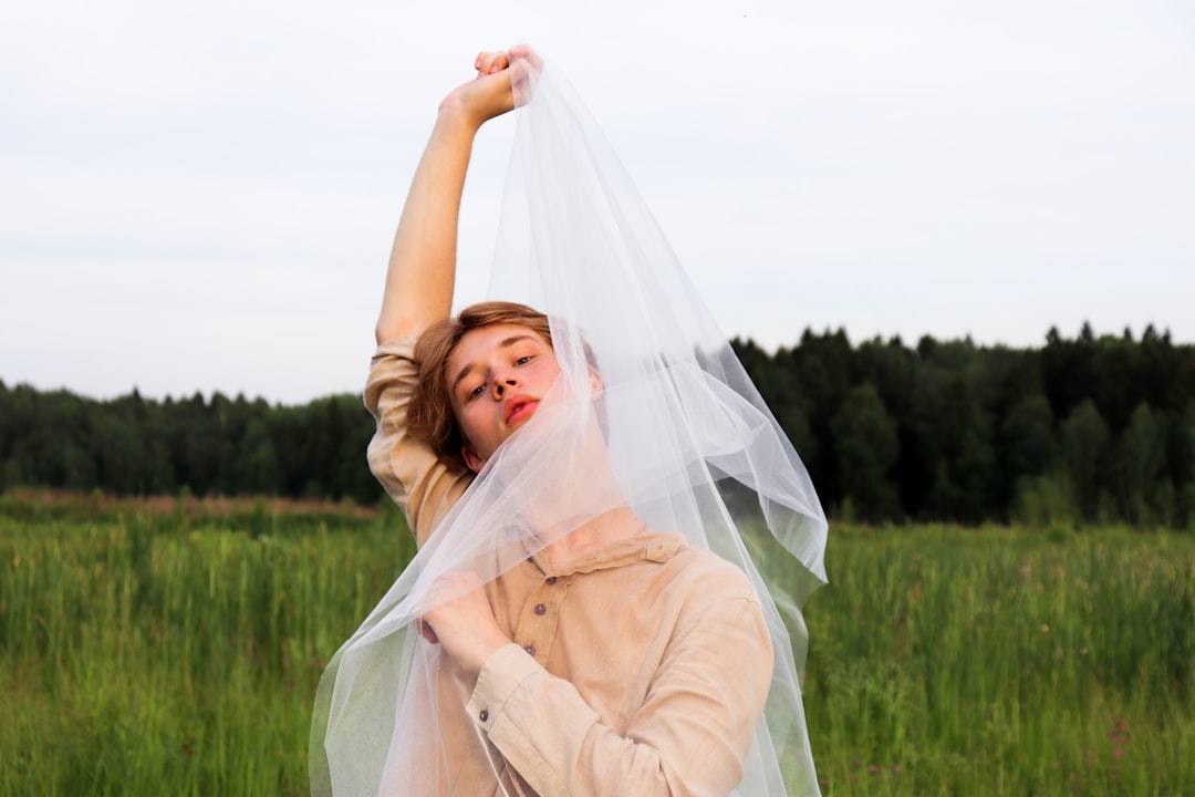 woman in white dress on green grass field during daytime