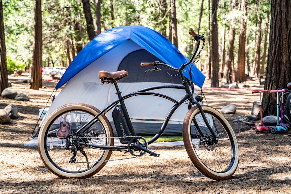 black bicycle beside blue tent