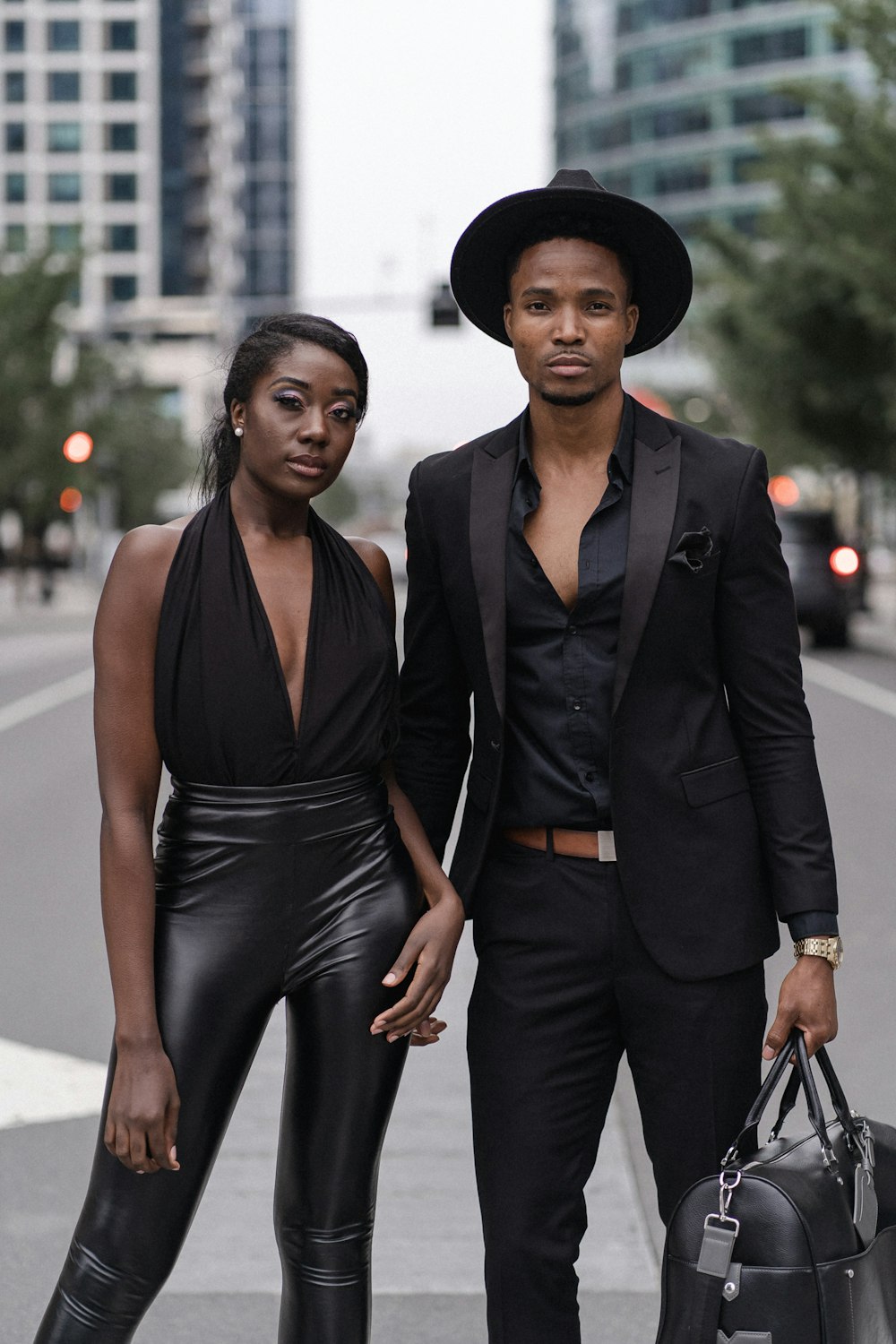 woman in black dress and black blazer standing beside woman in black dress