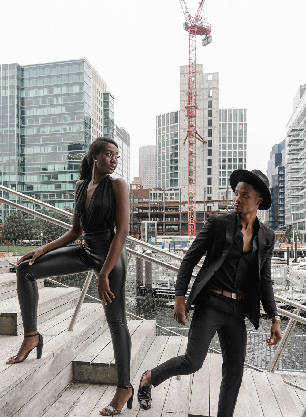 man and woman standing on gray metal railings during daytime