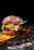 Close-up of a corrugated burger box holding a gourmet burger with fresh toppings.