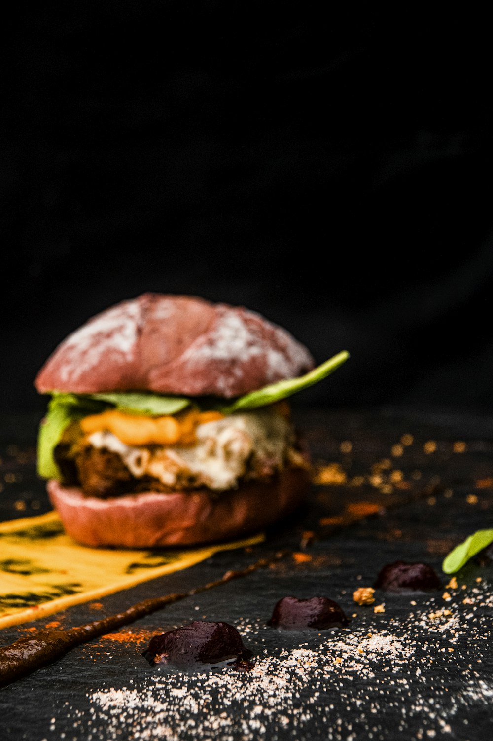 burger on black and yellow plate