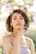 woman in white tank top with gold necklace