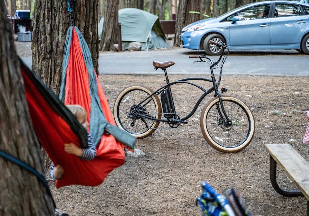 black commuter bike near red and black hammock