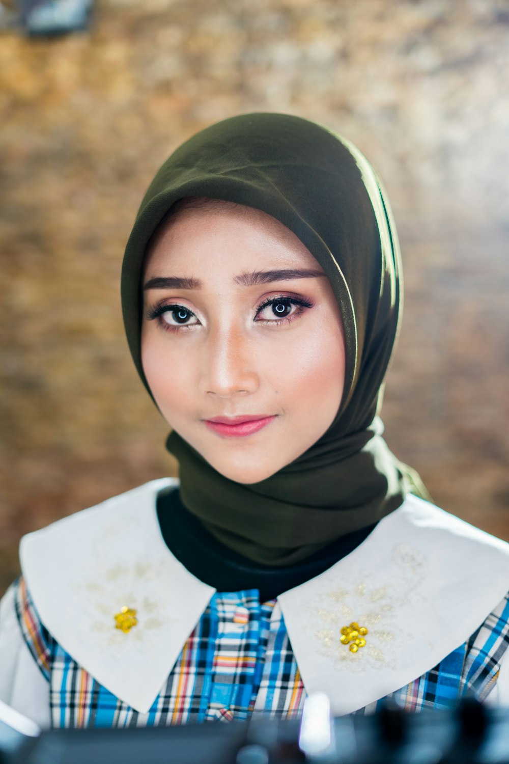 woman in white and yellow floral hijab