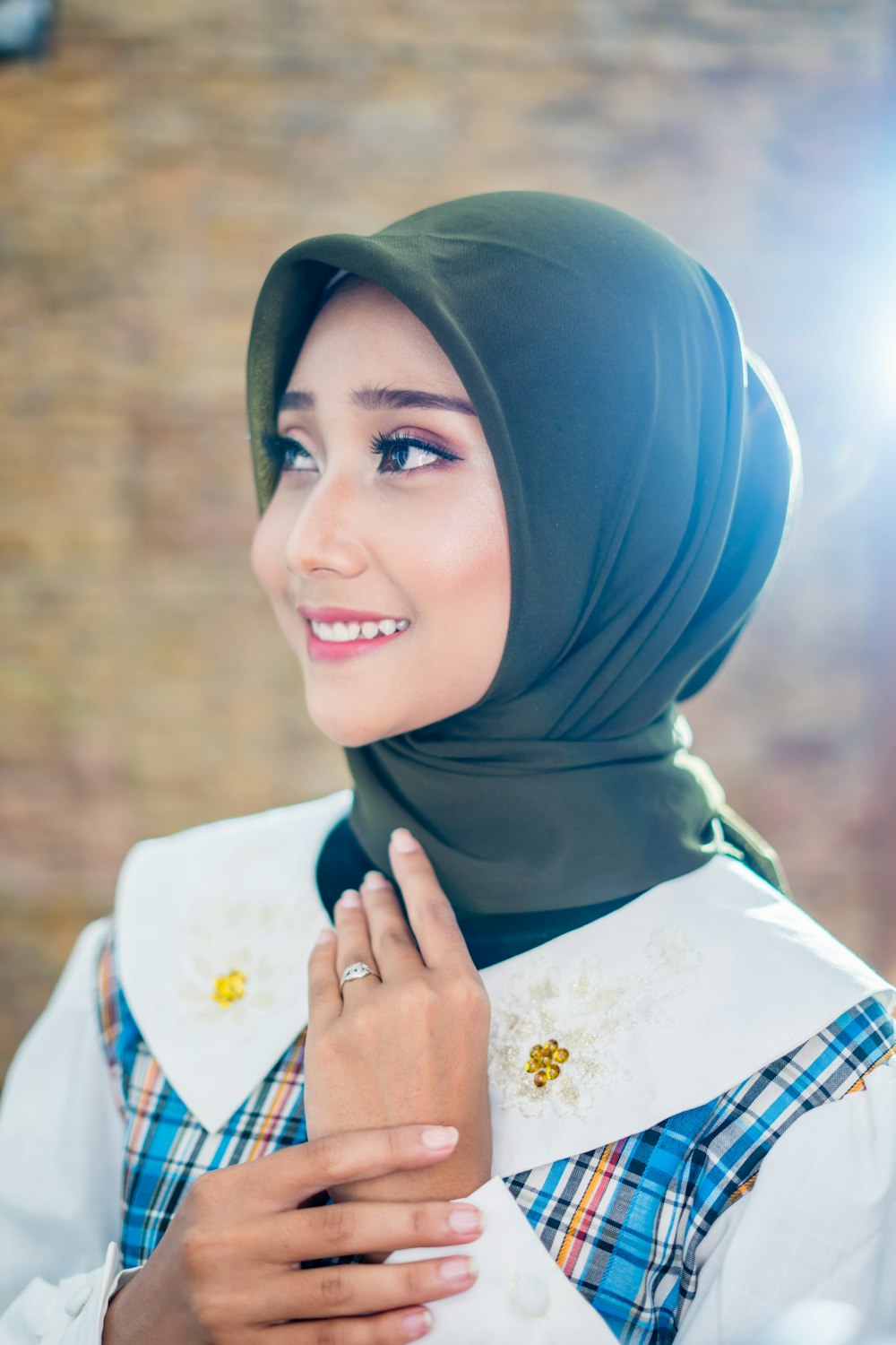 woman in blue hijab smiling
