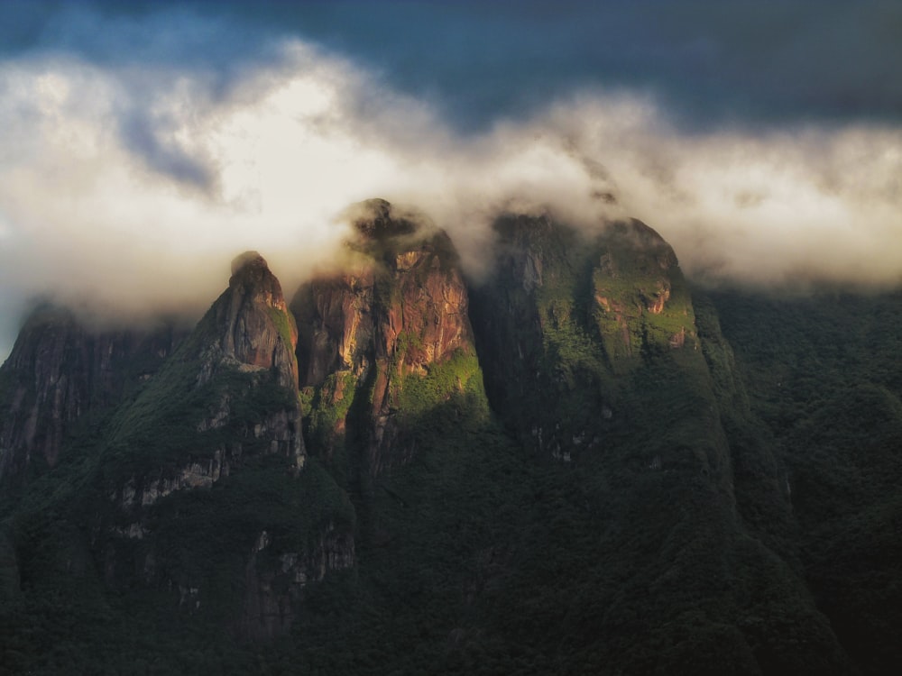 green and brown mountain under white clouds