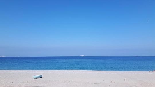 white boat on white sand beach during daytime in Scilla Italy