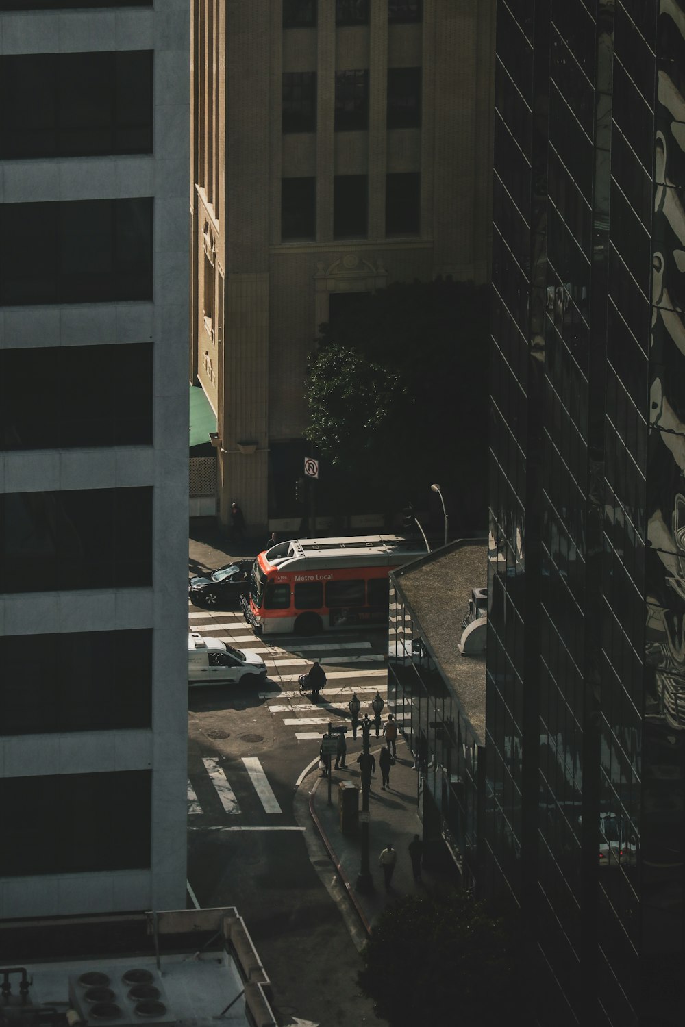 red car parked beside brown building