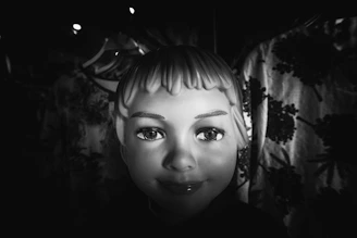 Luxurious shot of a styled wig on a mannequin head with soft shadows and a clean background.