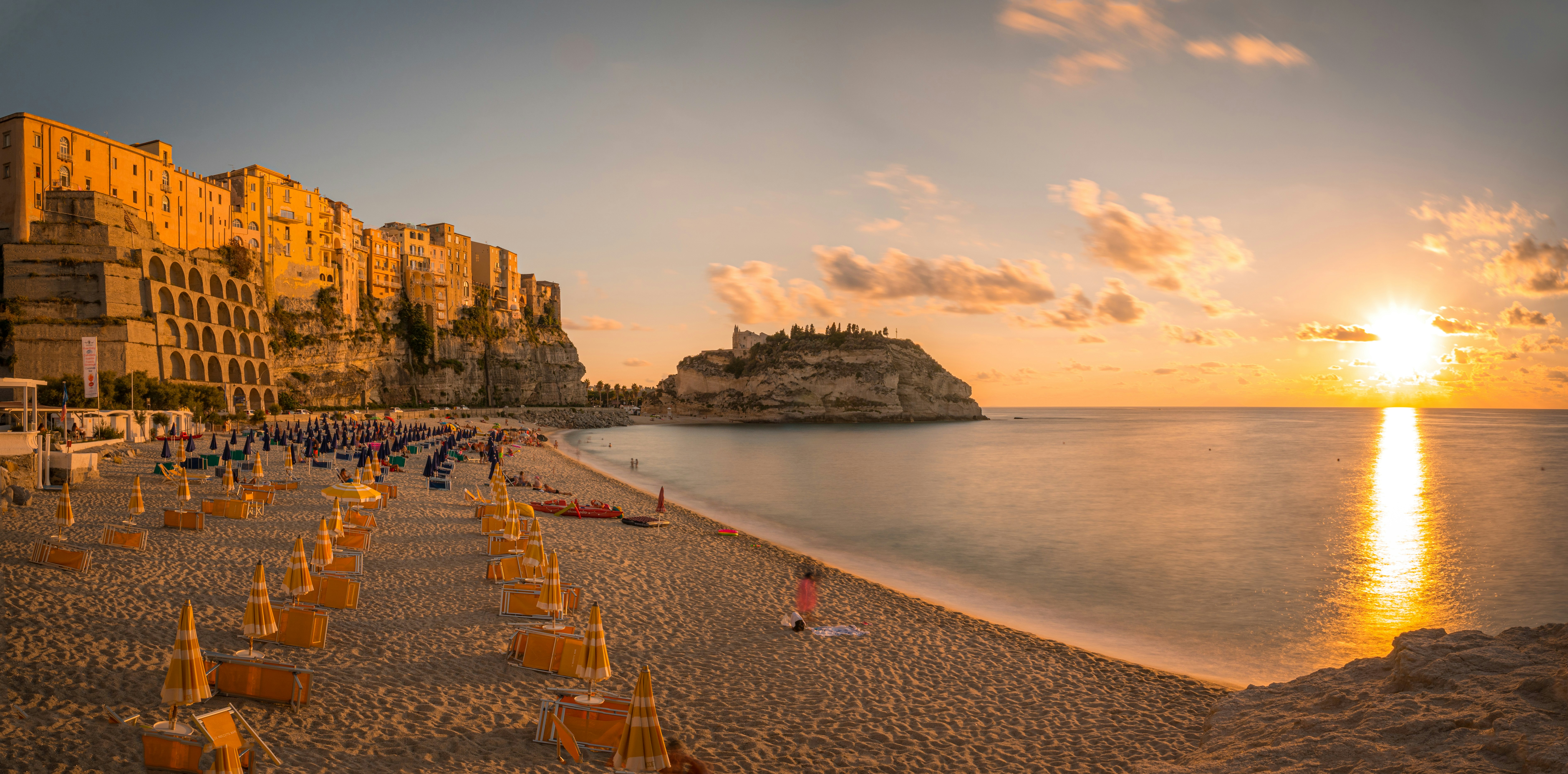 people on beach during daytime, Sunset on the Tropea beach. Panorama from 3 photos.
