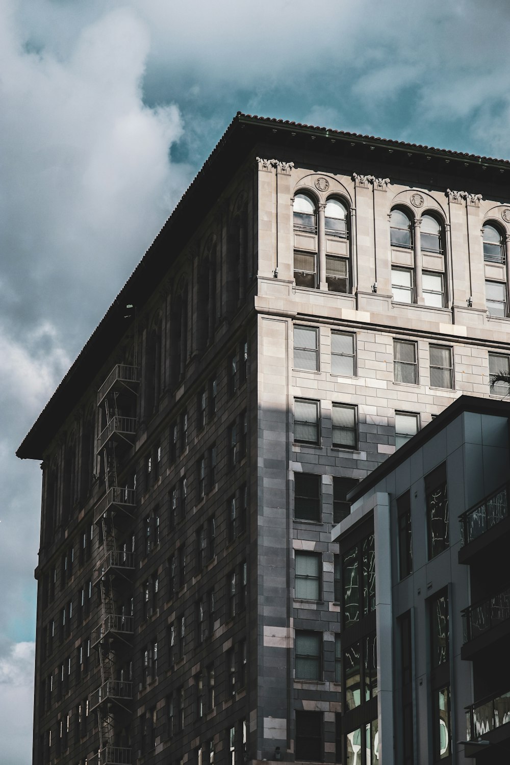 brown concrete building under cloudy sky during daytime