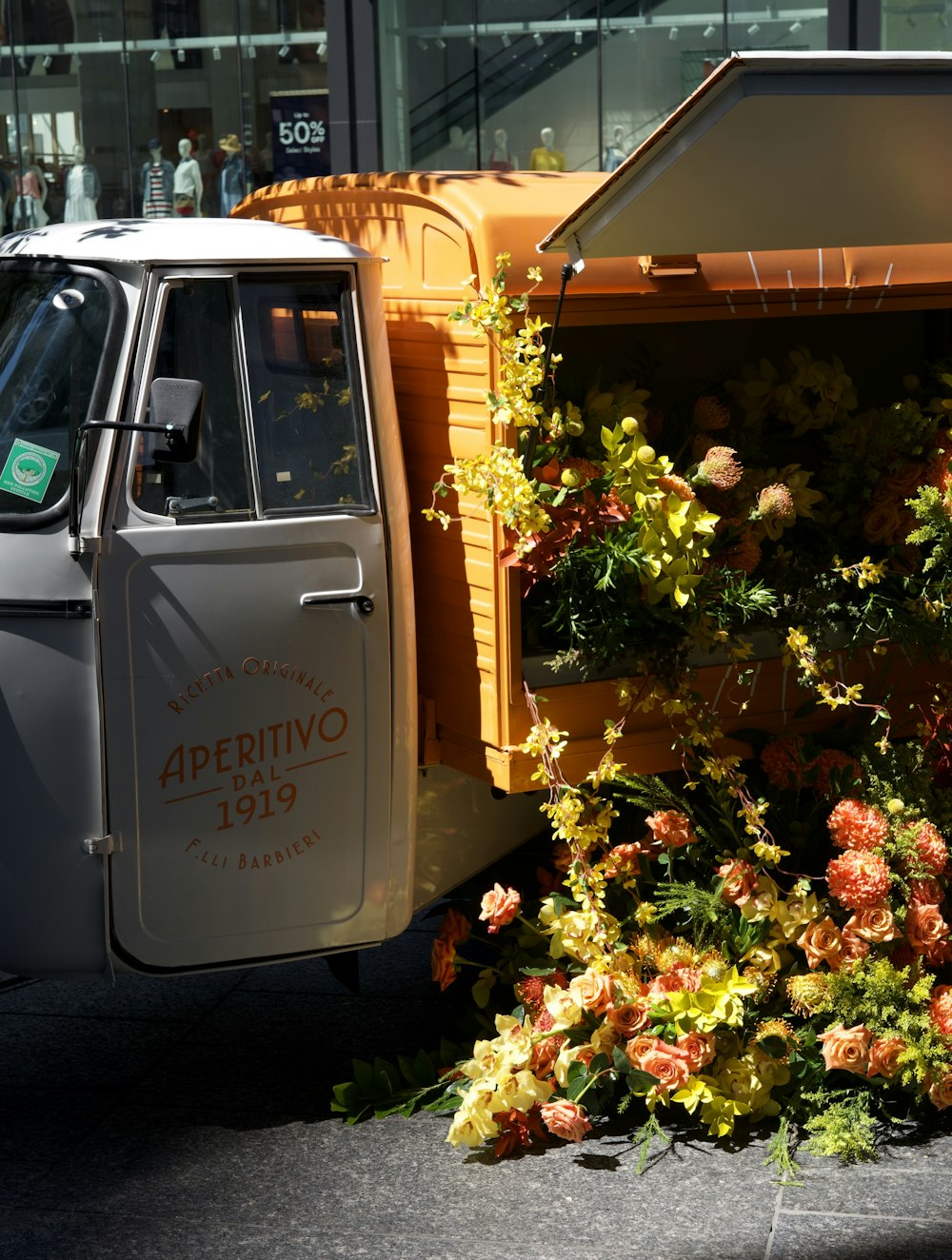 yellow and red flowers on white truck