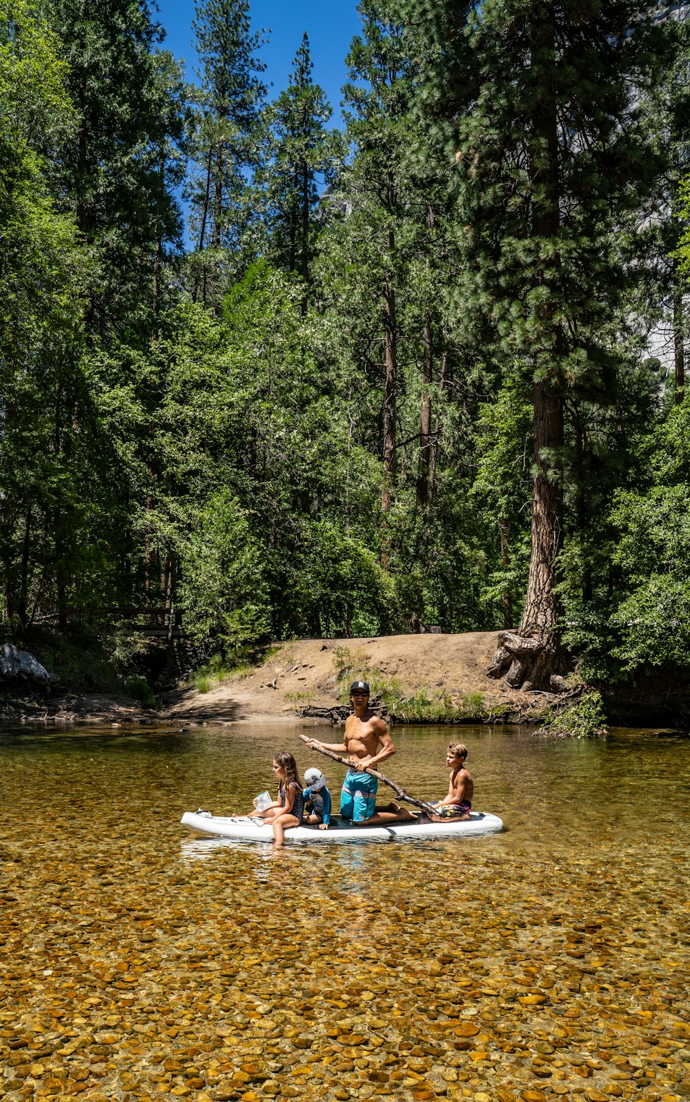 2 women riding on white kayak on river during daytime