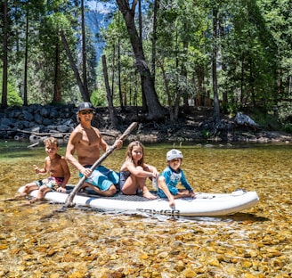 3 women and 2 men riding on boat during daytime