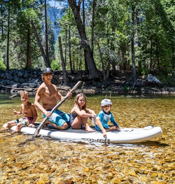 3 women and 2 men riding on boat during daytime